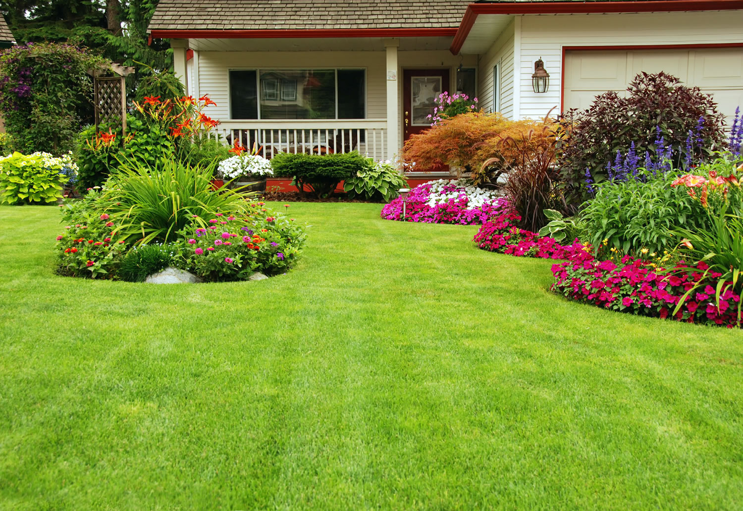 Plush green lawn and landscaped areas with flowers